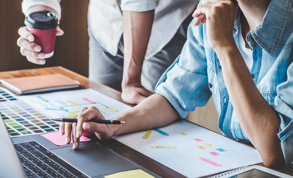 team members looking at laptop together