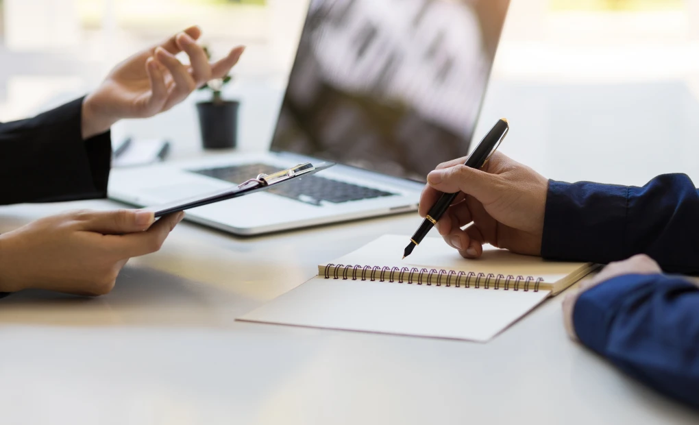 two people sitting at a desk